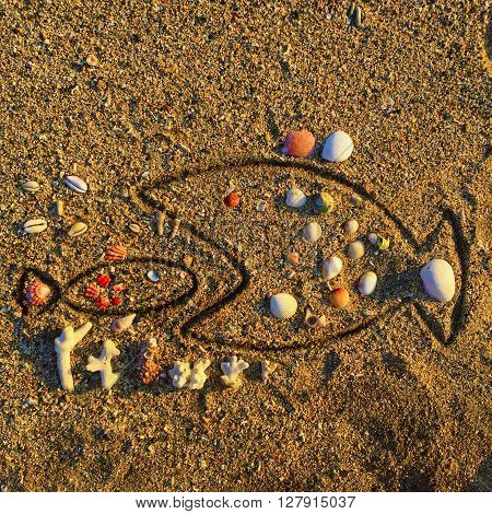 Large fish attacks small fish beach drawing on sand, sea beach drawing