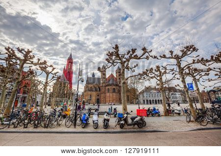 Maastricht Netherlands - April 11 2016: Vrijthof in Maastricht with unidentified people. Vrijthof the largest and best-known square in Maastricht with many well-known pubs and restaurants