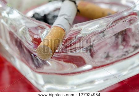 Cigarette butt in ashtray in close up view.Shallow DOF.