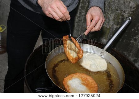 Cooking The Big Fried Fritters Dipped In Boiling Oil In An Alumi