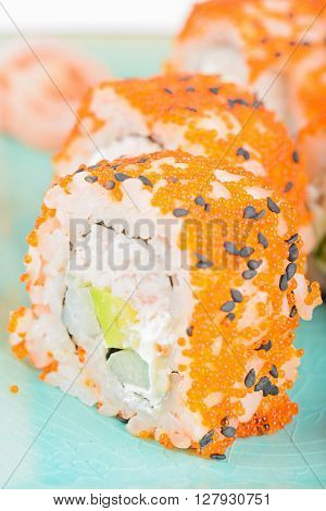 California maki sushi with masago. Roll made of crab meat, avocado, cucumber and masago.