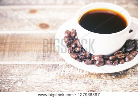 Porcelain coffee cup with beans on saucer