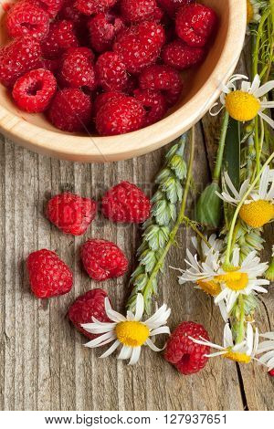 Fresh Ripe Raspberries And Camomile Flowers