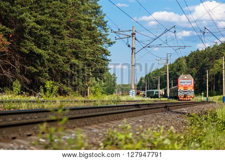 Electric train goes by rail, summer, countryside sunny