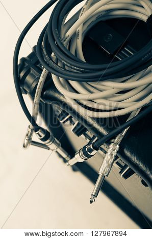 Close-up of guitar amplifier with jack cable.