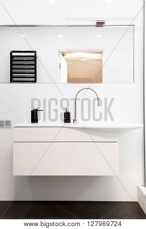 Modern design solution bathroom in black and white. Luxurious ceramic sink and elegant mixer