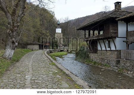 Etar,  Gabrovo, Bulgaria - April 13, 2012: Old traditional houses, old traditional clock tower  and river with bridge in Etar, Gabrovo, Bulgaria. Visit of Gabrovo region in springtime.