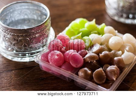 Aalaw candy in plastic tray on wood table