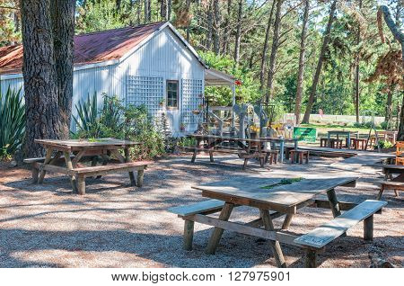PLETTENBERG BAY SOUTH AFRICA - MARCH 3 2016: Rustic benches and tables at a farm stall at The Heath near Plettenberg Bay on the road to Knysna