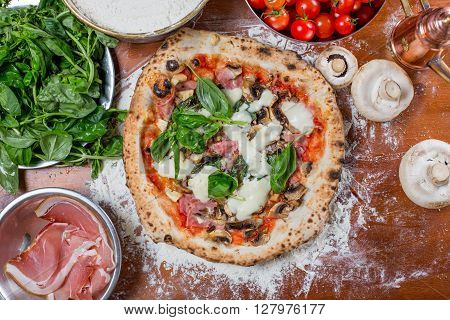Pizza Capricciosa With Artichoke, Ham And Mushroom On Wood Background