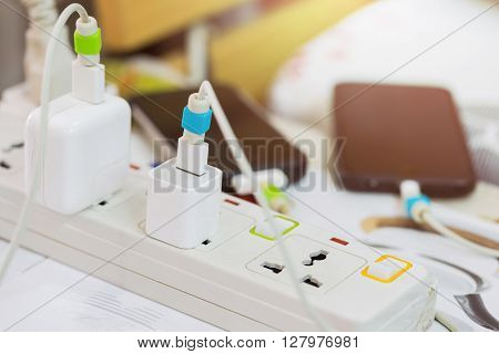 Electrical appliances pluged several adapter and charger.