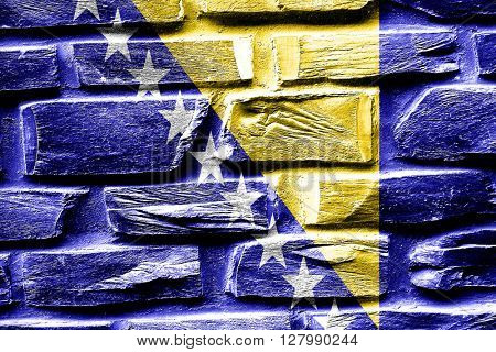 Brick wall Bosnia and Herzegovina flag with some cracks and vint