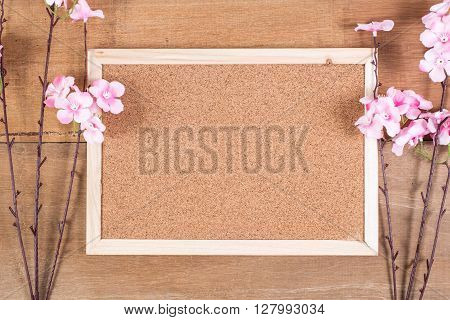 The plastic sakura with cork board on plank