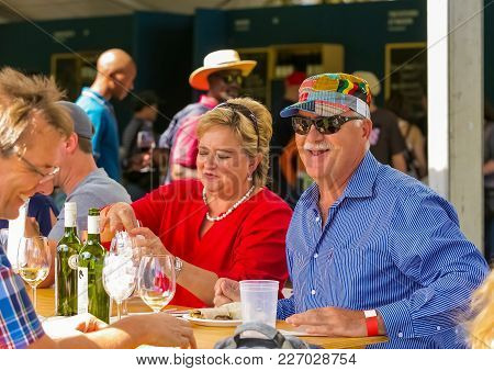 Johannesburg, South Africa, 05/10/2014,  Middle Aged Couples Enjoying Wine With Friends At The Winte