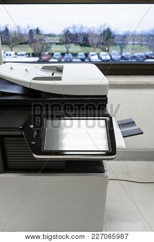 Big Copier With Touchscreen Display In Office Hall Near Window In Autumn Rainy Day