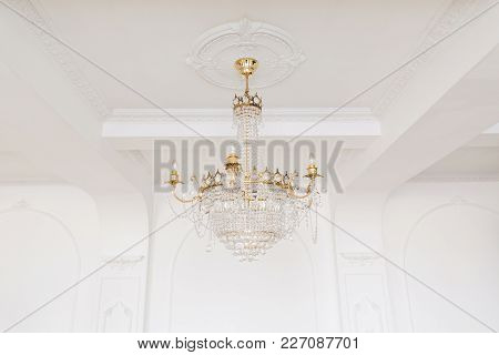 Expensive Interior. Large Electric Chandelier Made Of Transparent Glass Beads. White Ceiling Decorat