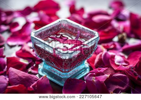 Rose Syrup,rosa Syrup With Rose Petals On A Wooden Surface Are The Ingredients For The Preparation O