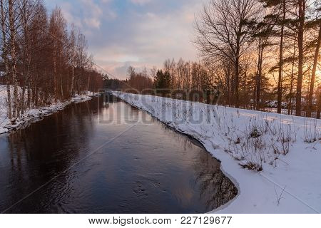 Straight Channel And A Beautiful Sunset Sky With Snow On The Side