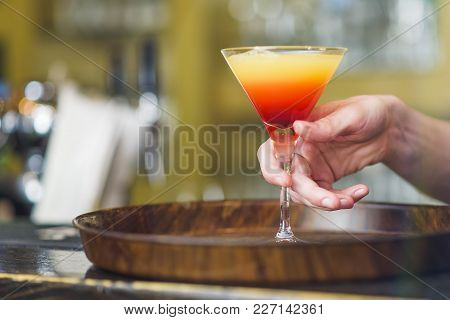 Young Bartender Making A Colorful Cocktail, Pouring Alcohol In A Cocktail Glass