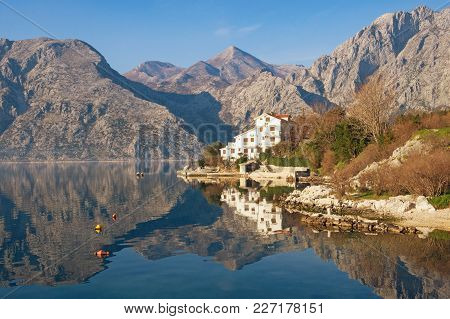 Mountains And Coast With White Building Are Reflected In The Water. Montenegro, Bay Of Kotor, Dobrot
