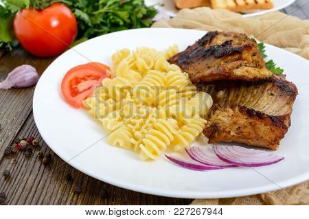 Pasta Radiatori And Fried Rabbit Ribs. Close Up