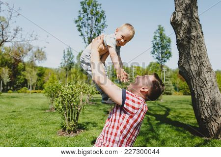 Joyful Man Walk On Green Park, Rest, Have Fun, Play, High Toss Up Little Cute Child Baby Boy Sit On 