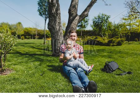 Joyful Man Walk On Green Park, Rest, Have Fun, Play, High Toss Up Little Cute Child Baby Boy Sit On 