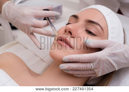 Keep Your Beauty! Young Woman Lying With Pleasure Gets Beauty Facial Injections In The Cosmetology S