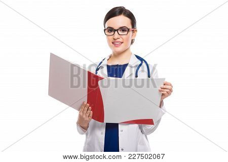 Portrait Of Young Attractive Female Doctor In White Coat Standing In Office Smiling Looking In Camer