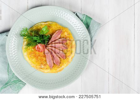 Breakfast Of Scrambled Eggs And Meat With Tomatoes Shot Close-up
