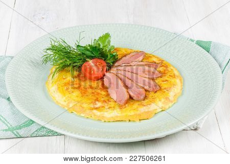 Breakfast Of Scrambled Eggs And Meat With Tomatoes Shot Close-up