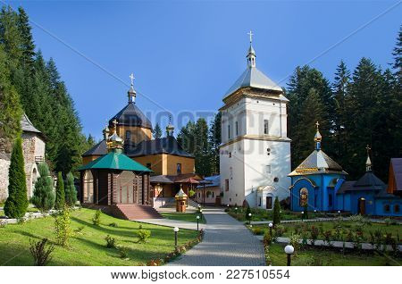 Old Monastery On Sunny Day Against The Blue Sky In Maniava, Ivano-frankivsk Region In Ukraine. Horiz