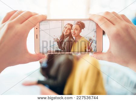 Picture Of Somebody Taking A Picture Of Two Best Friends That Are Happy To See Each Other. They Have