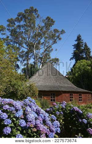 Frutillar, Los Lagos, Chile - January 24, 2018:  Traditional Wooden Farm Buildings Set In The Landsc