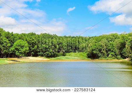 Summer Day Landscape With Wooden Pontoon Bridge On A Forest Lake. Marshalkovo Park, Stroitel Town Di