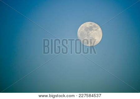 The Full Moon In A Blue Sky Without Stars Or Clouds