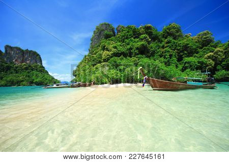 Thale Waek Separated Sea With Wooden Thai Boats, Kra Bi Andaman Sea Of Thailand Against Beautiful Cl