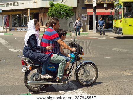 Tehran, Iran - May 19, 2017: Family On A Motorcycle On Tehran Road. Tehran Is The Capital Of Iran.