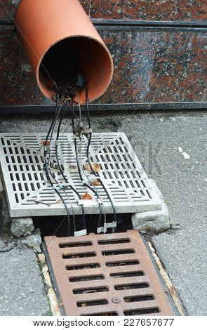 Gutter Deicing System. Gutter Heating. Close Up On Gutter Downspout Drainage Pipeline Deicing Cable 