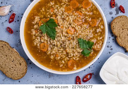 Traditional Spicy Soup With Rice And Vegetables In A Plate On The Table. Selective Focus.