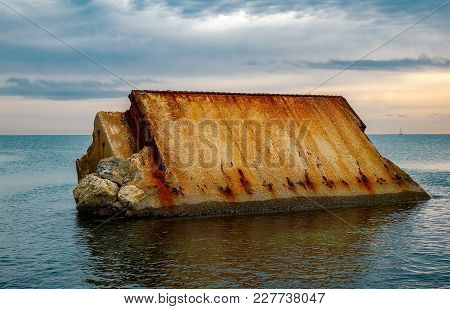 The Rock In The Sea With Clouds