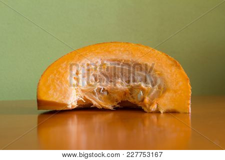 Slicing Pumpkins For Soup Or Pie On The Kitchen Table