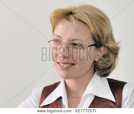 Closeup Portrait Of A Happy Goal-oriented Business Woman Sitting In Her Chair At The Desk In Office.