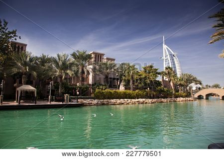 DUBAI, UAE - FEBRUARY, 2018: View on Burj Al Arab, the world only seven stars fotel seen from Madinat Jumeirah, is a luxury resort which include hotels and souk spreding across over 40 hectars.