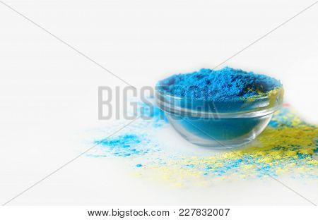 Indian Holi Festival Blue Colour In Bowl On White Background. With Text Space