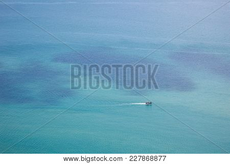 Photograph Of A Fisherman Boat Sailing In The Sea.