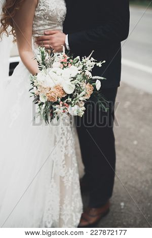 Beauty Wedding Bouquet With Different Flowers In Hands.