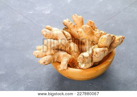Spicy Root Of Ginger On A Wooden Table