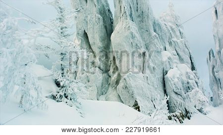Snowy Rock In The Forest. Video. Snowy Rocks In The Mountains With Clear Sky. Snowy Mountain With Fo
