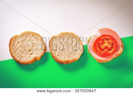 Two Slices Of Fresh Bread With Sesame Seeds In Crust, One Open Sandwich With Slices Of Cheese, Cooke